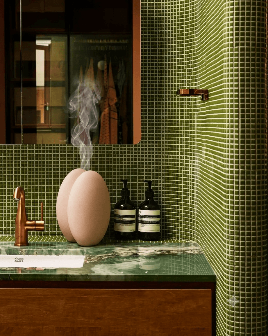 Diffuser on a green mosaic basin, boutique-hotel mood